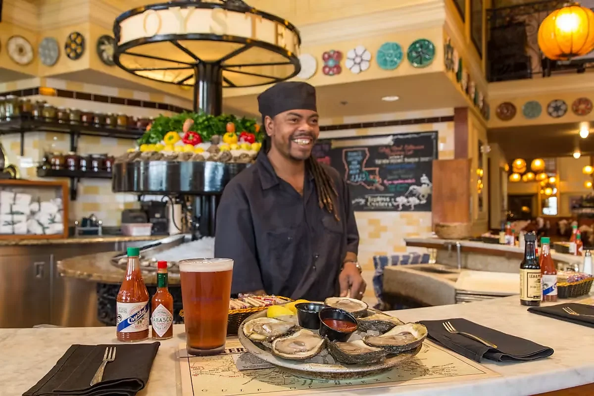 Oyster bar counter with raw oysters, beer and hot sauce bottles