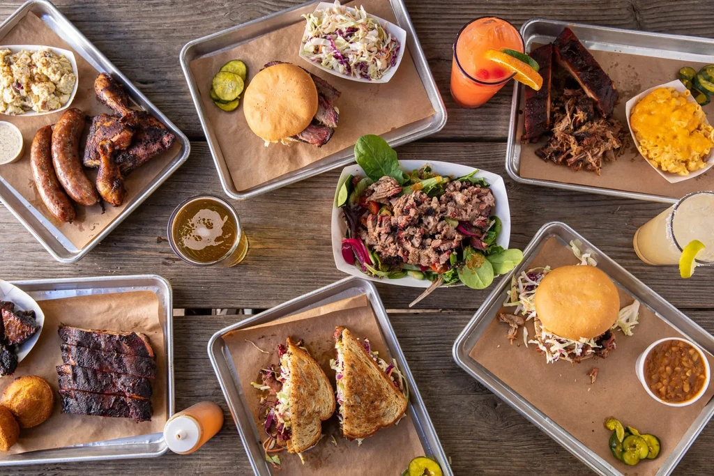 Overhead shot of a large BBQ food and drinks spread.
