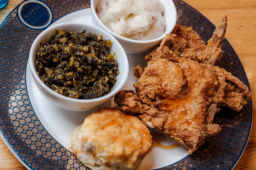 Crispy fried chicken, biscuit, greens, mashed potatoes from NOPSI Hotel.