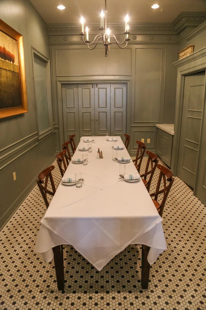 Elegant private dining room with a long table set for ten.