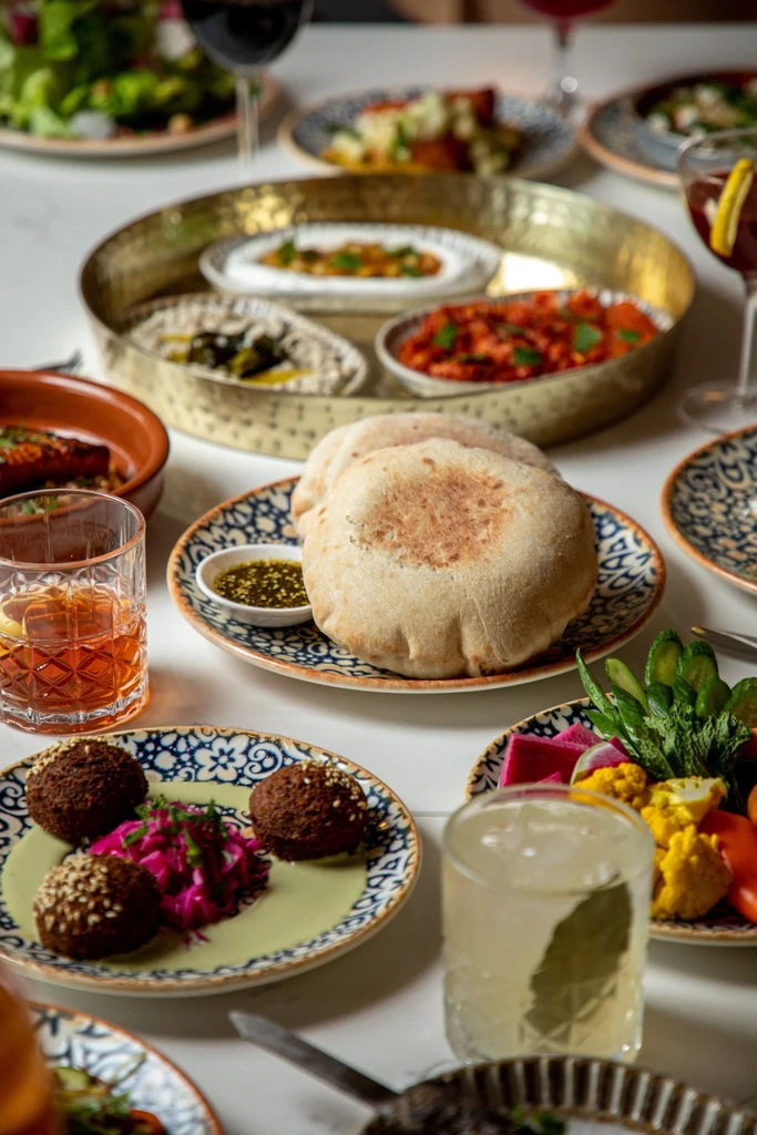 Overhead shot of a vibrant Middle Eastern food spread.