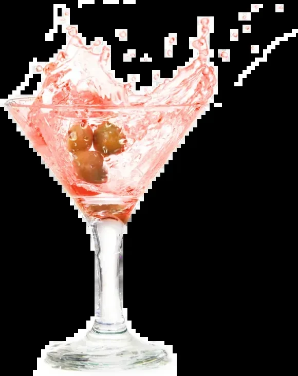 Pink cocktail with three olives splashing out of a martini glass.
