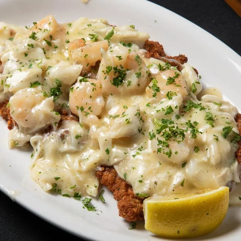 Fried seafood with creamy sauce, shrimp, crab, parsley, and lemon.