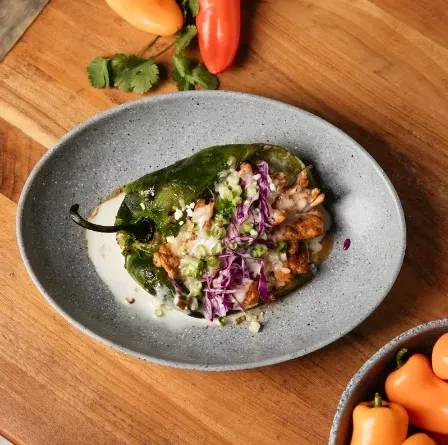 Roasted green pepper stuffed with chicken, melted cheese, and creamy sauce.