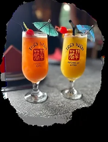 Trey Yuen orange and yellow cocktails with cherry and umbrella garnishes.