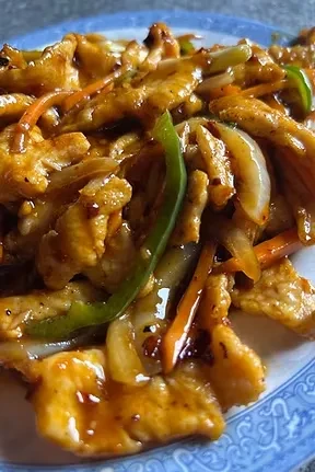 Spicy chicken stir-fry with vegetables and orange sauce.