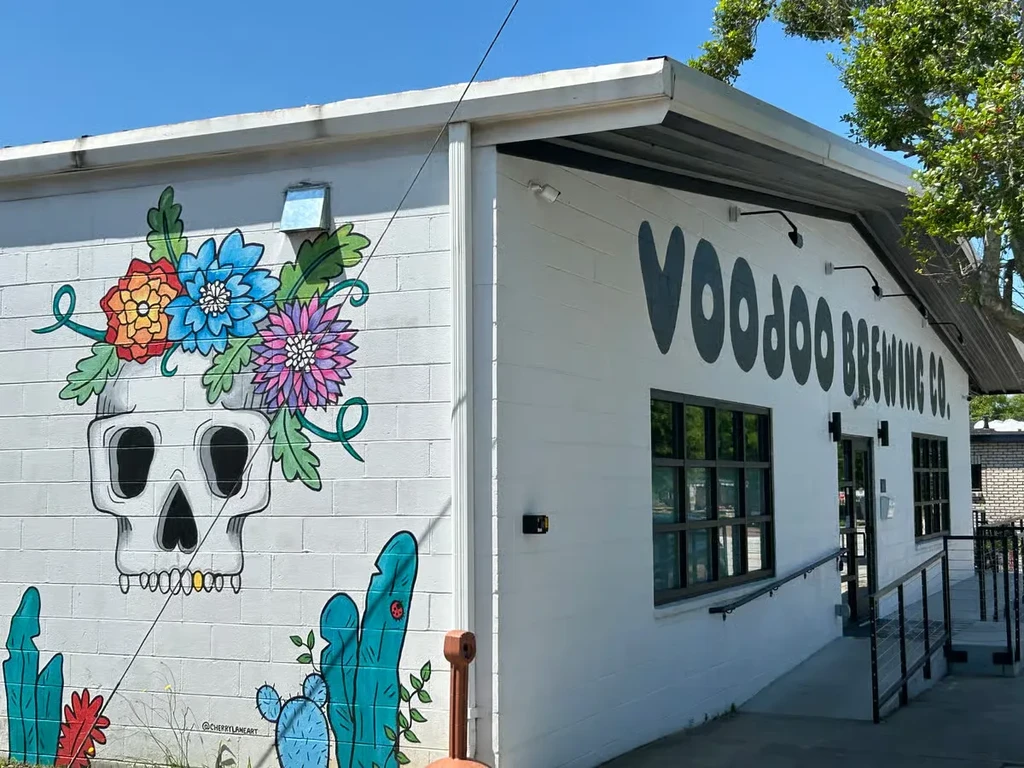 Voodoo Brewing Co. building featuring a vibrant skull and floral mural.
