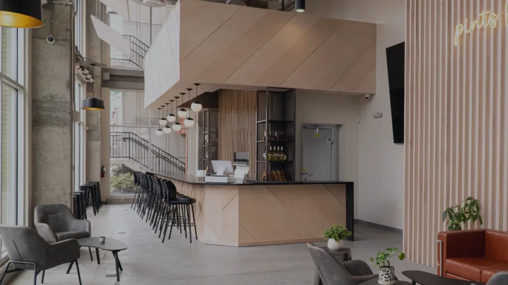 Modern, spacious bar and lounge interior featuring a patterned wood bar.
