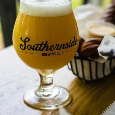Light amber beer in a Southernsde Brewing Co. glass with snacks.