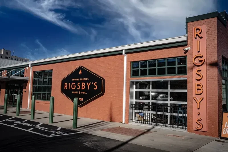 Rigsby's restaurant exterior: a brick building with prominent "Smoked Burgers" signage.