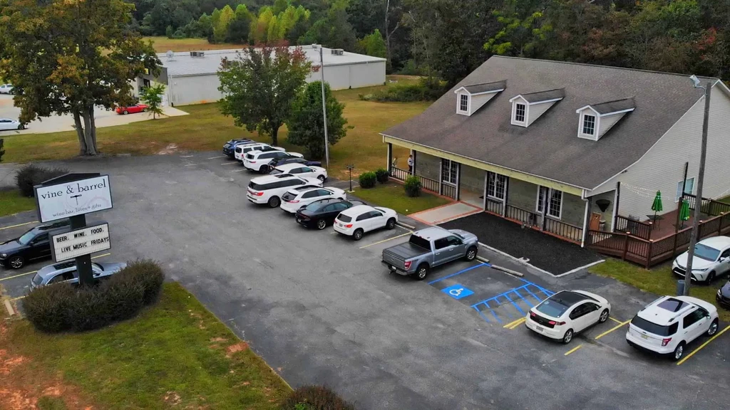 Elevated view of Vine & Barrel restaurant, full parking lot, patio.