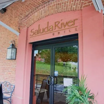 Exterior entrance of Saluda River Grill with brick and pink archway.