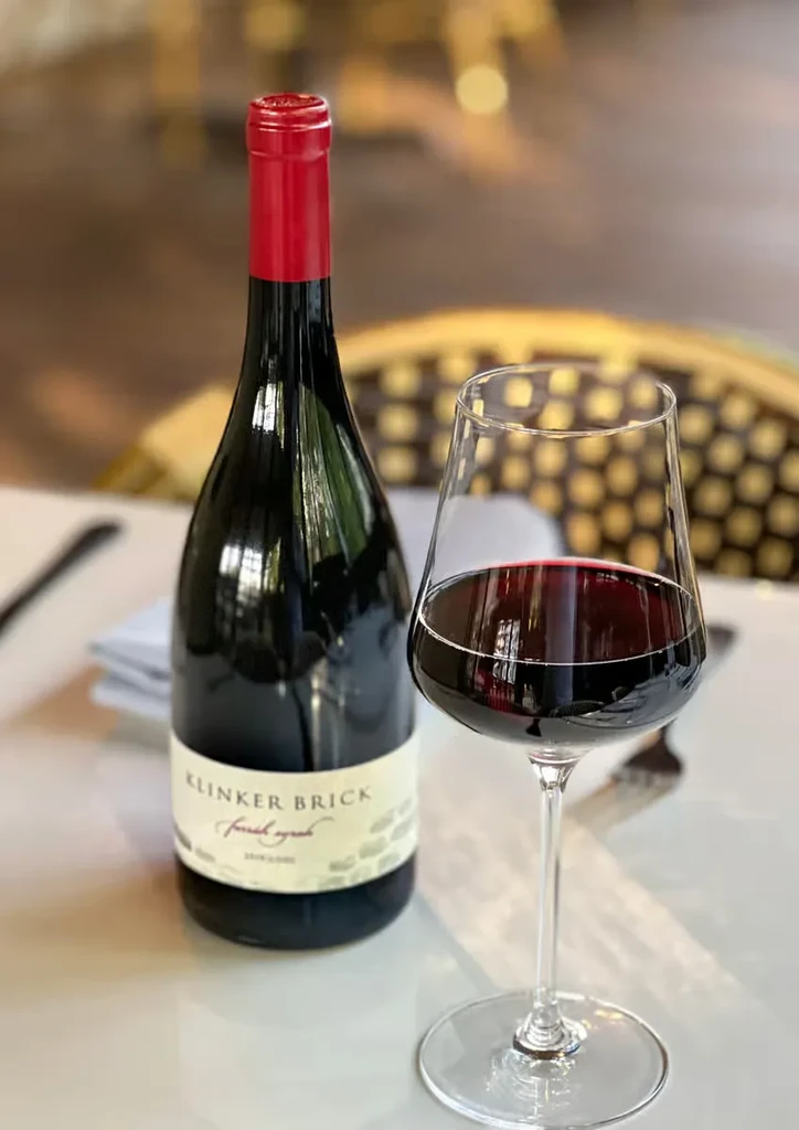 Klinker Brick fresh zinfandel wine bottle, glass of red wine.