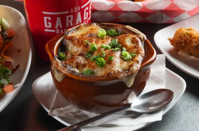 Rustic French onion soup with bubbly melted cheese and green onions.