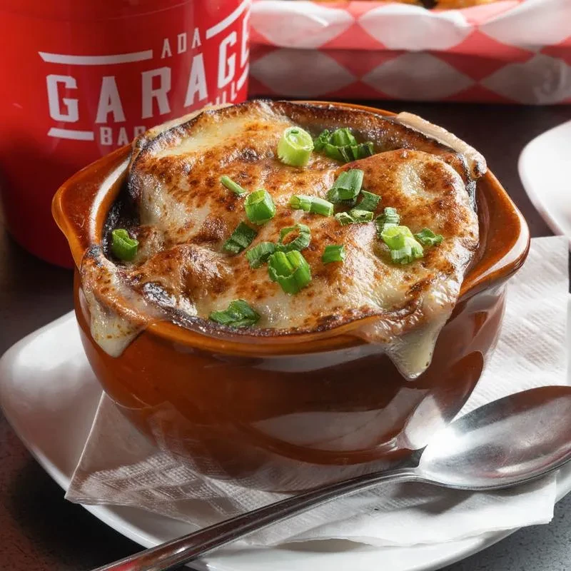 French onion soup in crock with melted, bubbly cheese and green onions.