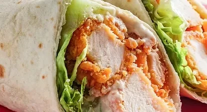 Chicken wrap cross-section with lettuce and sauce.