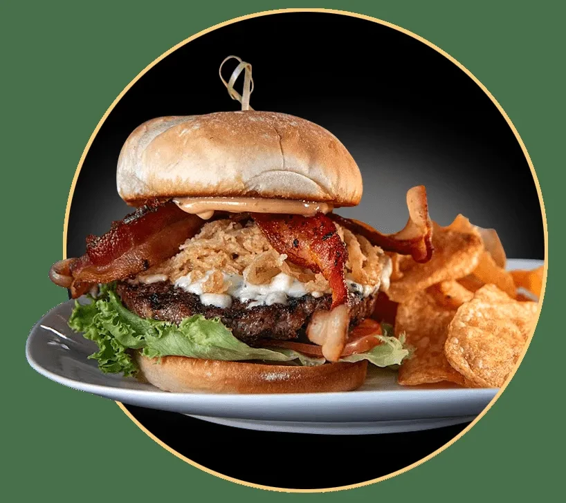Gourmet burger with bacon, cheese, crispy onions, and potato chips.