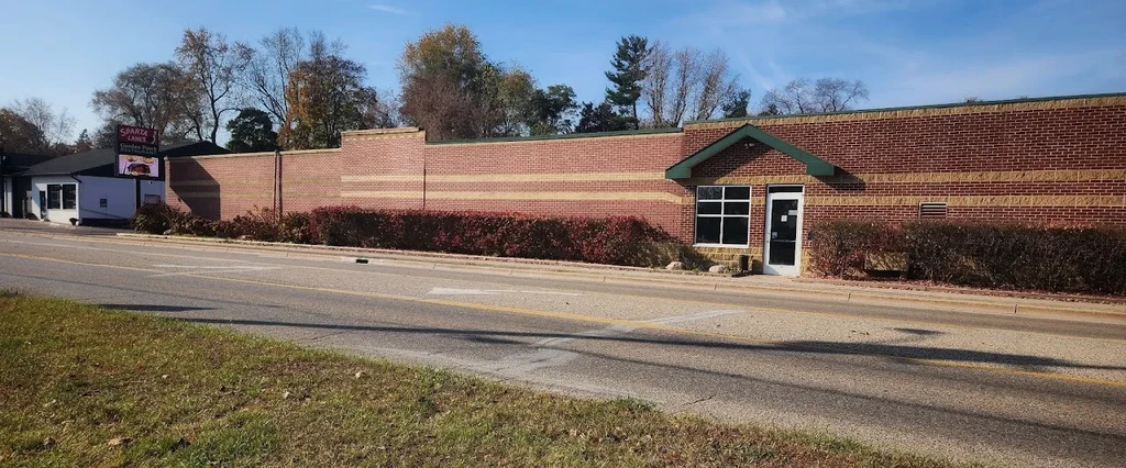 Exterior of Sparta Lanes and Garden Fresh Restaurant, a long brick building.