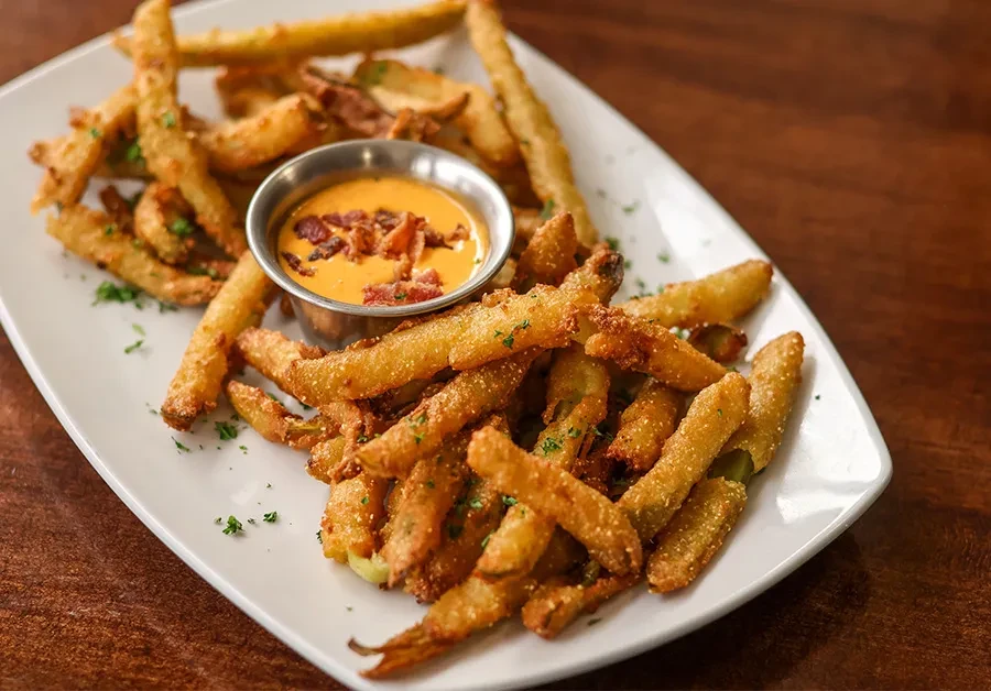 Crispy fried vegetables with bacon-topped orange dipping sauce.