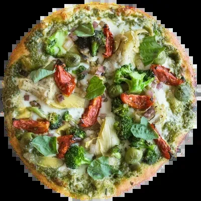 Overhead green pesto pizza with cheese and colorful vegetable toppings.