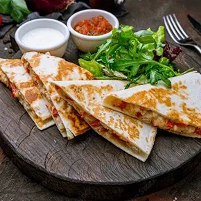Grilled chicken and cheese quesadillas with salsa, sour cream, and green salad.