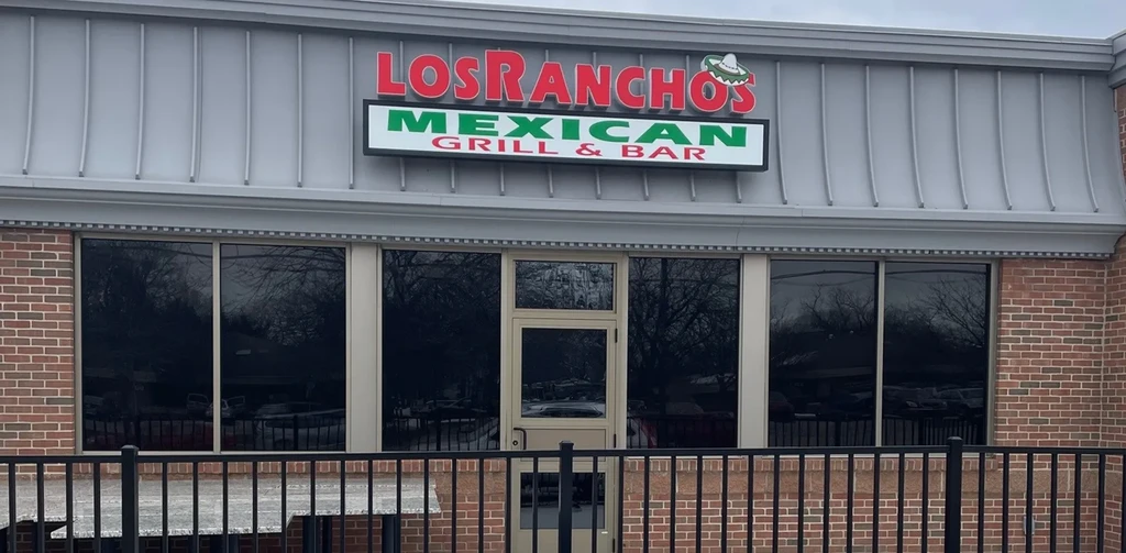 Los Ranchos Mexican Grill & Bar exterior with sign, windows, and brick.