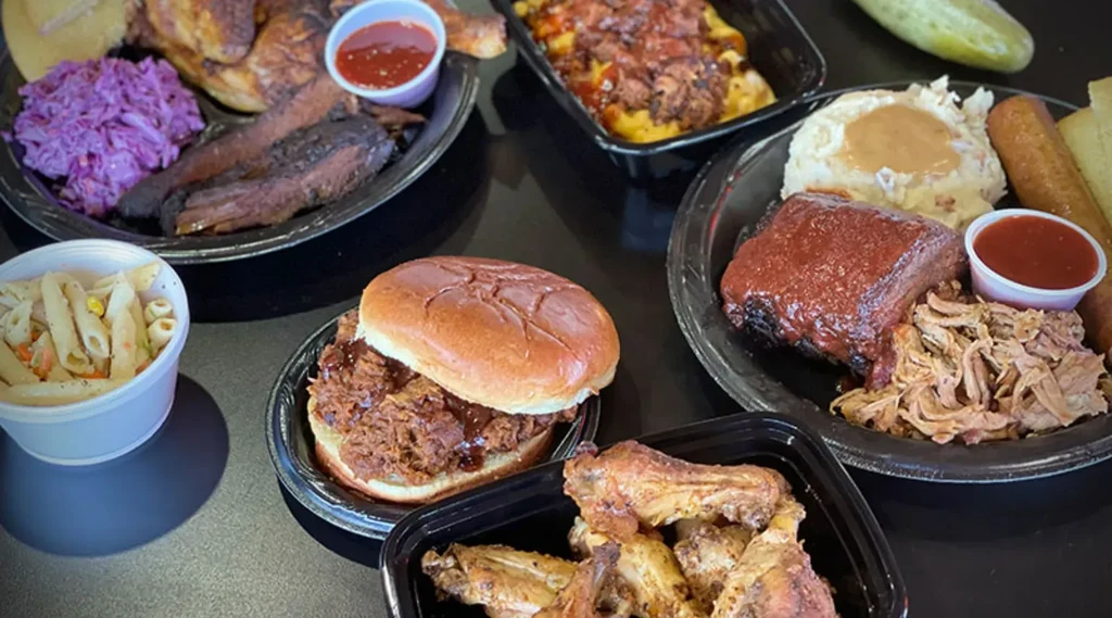 Barbecue spread with chicken, ribs, pulled pork, mac and cheese, and sides.
