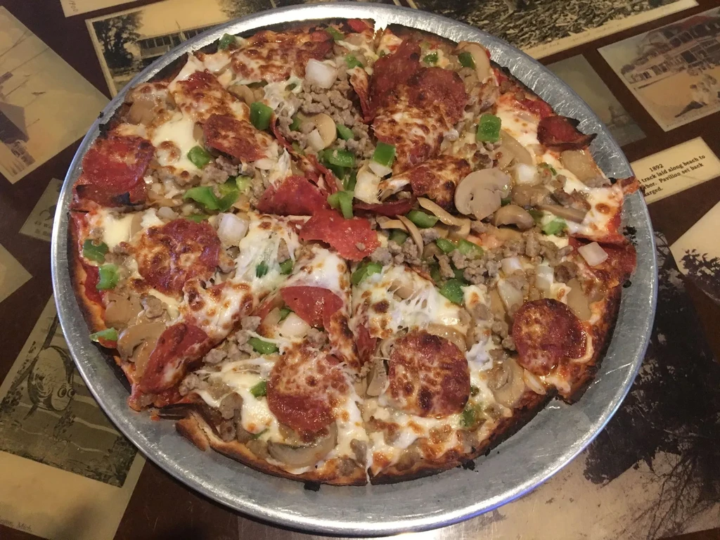 Loaded pizza with pepperoni, sausage, peppers, mushrooms, and onions.