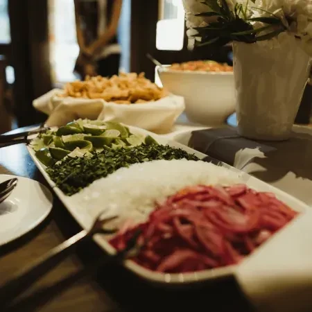 Platter with fresh lime, cilantro, diced and pickled onions.