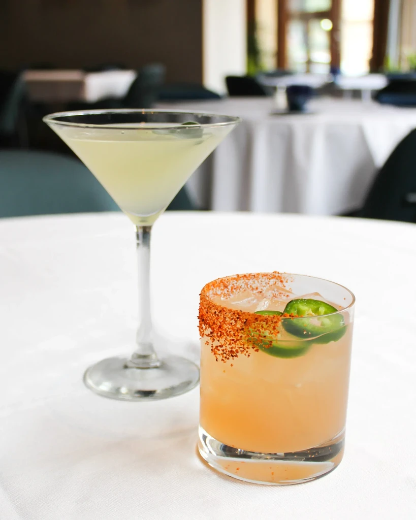 Martini and peach cocktail with jalapeño and chili salt rim.