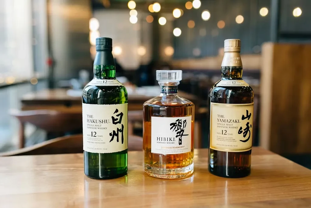Three Japanese whisky bottles: Hakushu, Hibiki, Yamazaki.