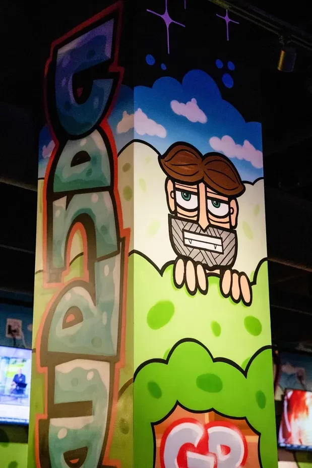 Vibrant pillar with graffiti-style 'CANDY' art and a cartoon character.