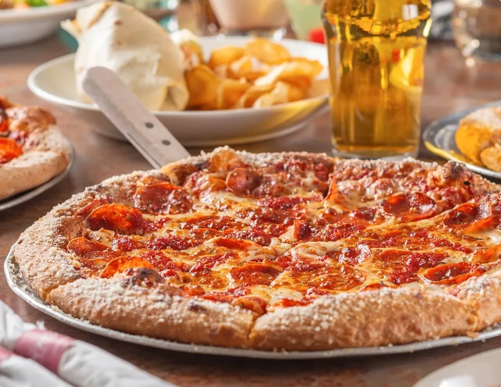 Freshly baked pepperoni pizza with melted cheese, one slice pulled.