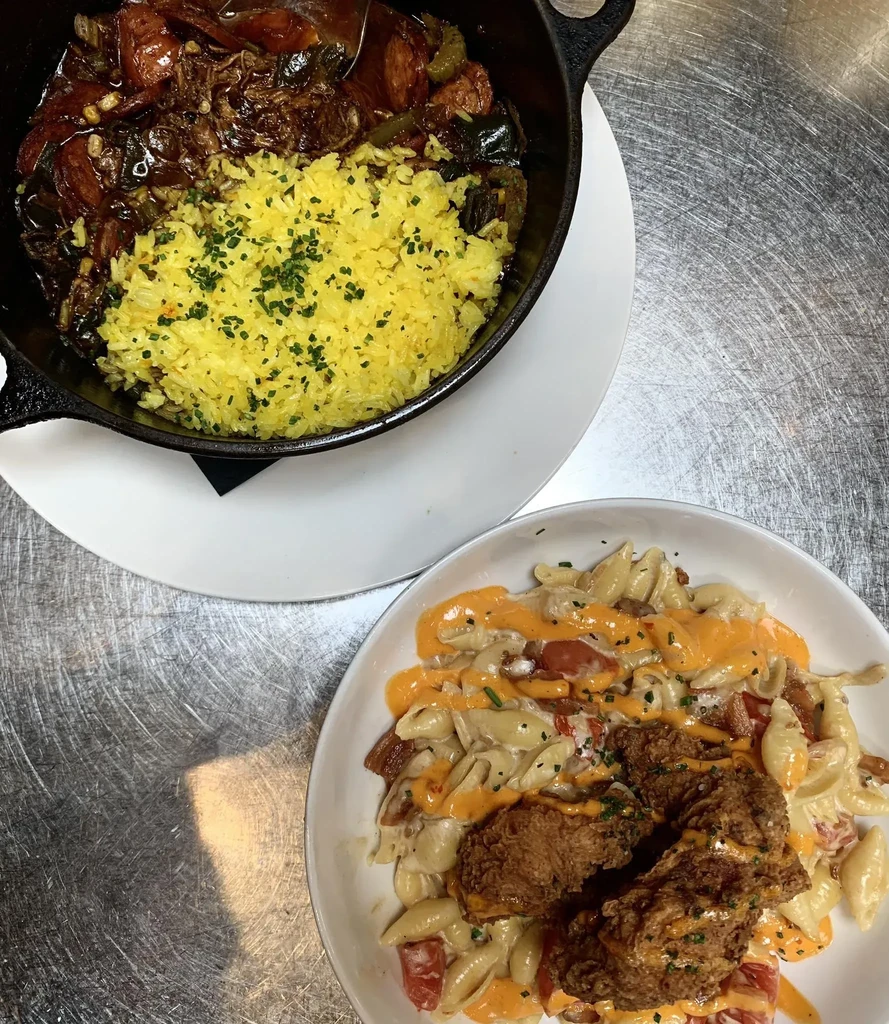 Overhead: stew with yellow rice, shell pasta with fried chicken.