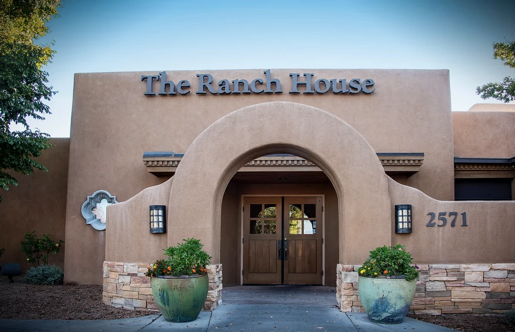 The Ranch House: tan Southwest-style building with arched entrance.