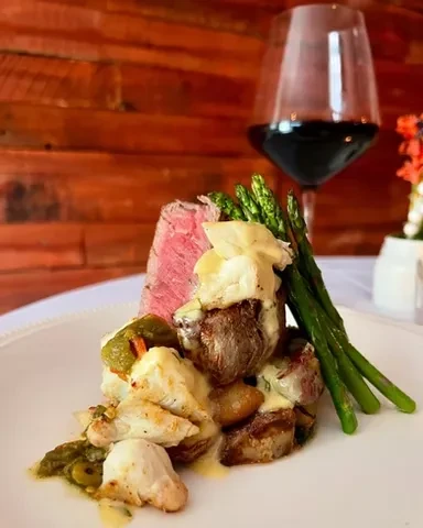 Medium-rare beef, crab, asparagus, and potatoes with creamy sauce.