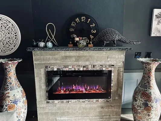 Modern electric fireplace, glowing purple flames, eclectic decor, and ornate vases.