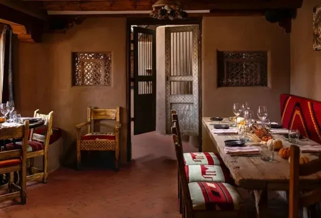 Warm Southwestern restaurant dining room with rustic tables and fall decor.