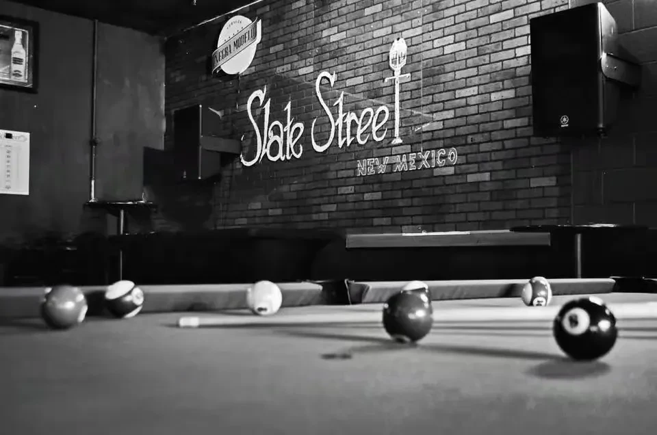 Black and white photo: Bar interior, pool table, "Slate Street" text.