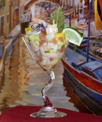 Shrimp and fruit ceviche in a twisted-stem glass.