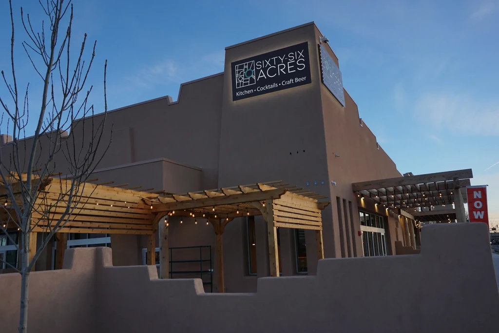Sixty-Six Acres, a modern Southwestern restaurant with outdoor pergolas and lights.