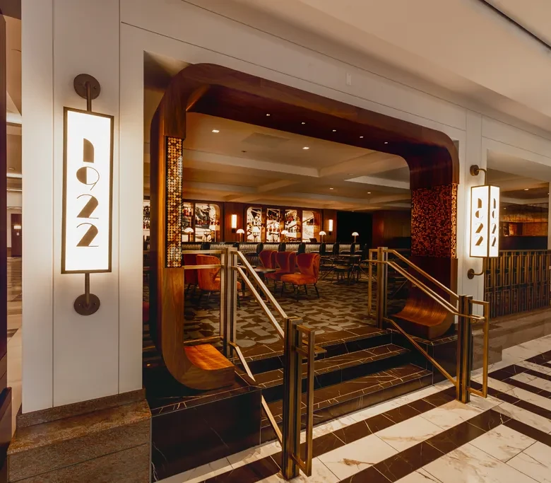 Upscale bar entrance with curved wooden archway and '1922' sign.