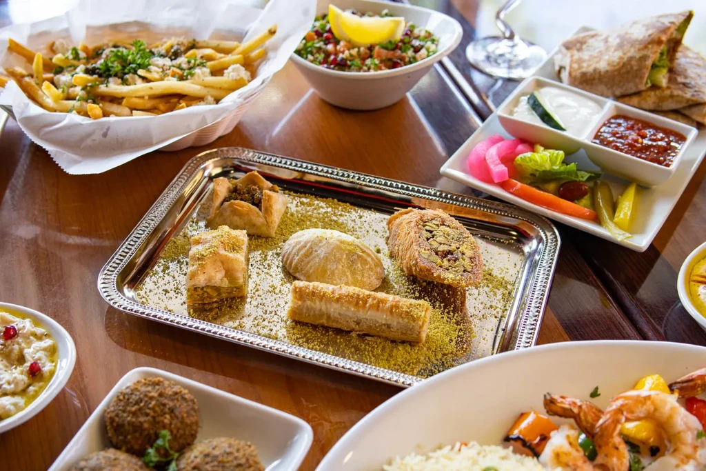 Vibrant Middle Eastern and Mediterranean dishes on a wooden table.