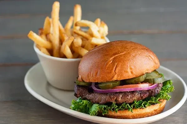 A classic burger and a side of golden, crispy french fries.