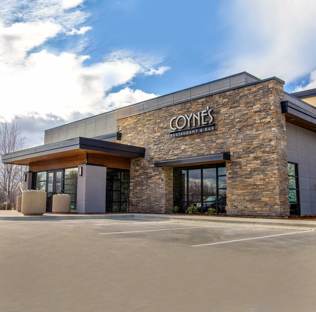 Coyne's Restaurant & Bar modern exterior, stone facade, empty parking lot.