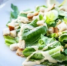 Fresh Caesar salad with romaine, croutons, Parmesan, and creamy dressing.