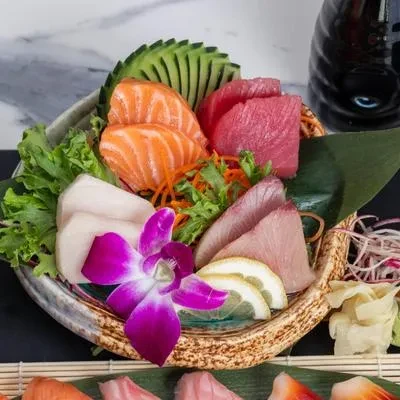 Japanese sashimi platter with salmon, tuna, white fish, ginger, and wasabi.