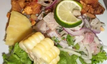 Plate of colorful ceviche, corn, pineapple, and crispy fried items.
