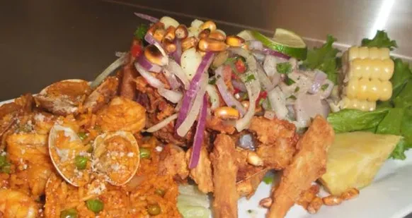 Overhead platter of Latin American rice, fried seafood, and ceviche.