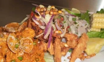 Peruvian fried seafood, ceviche, and clam rice platter.